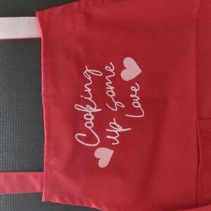 Red Apron with Heart Accent, adjustable neck, back tie & front pocket. NWT
